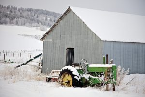 John Deere A in the Snow With Shed