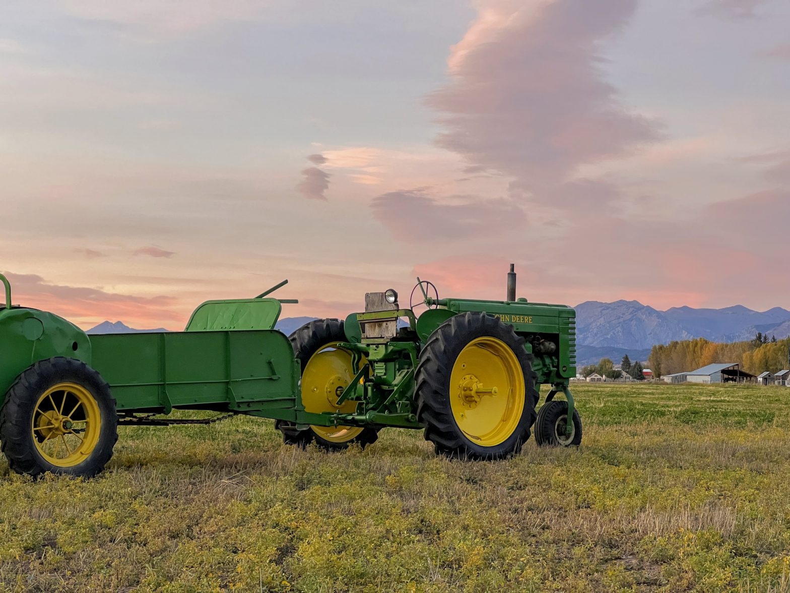 John Deere MT with Series H Number 47 Manure Spreader with Sunset and Mountains